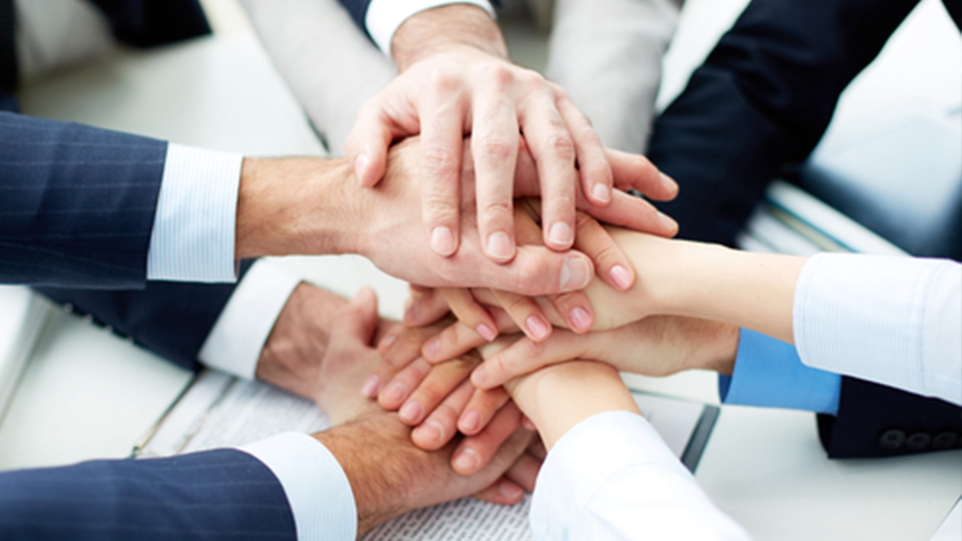 employee putting hands together in solidarity