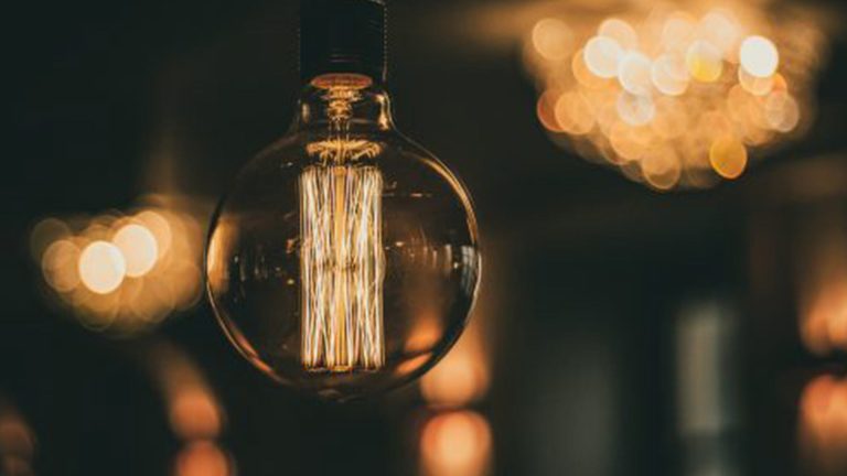 close up of hanging warm lit light bulb