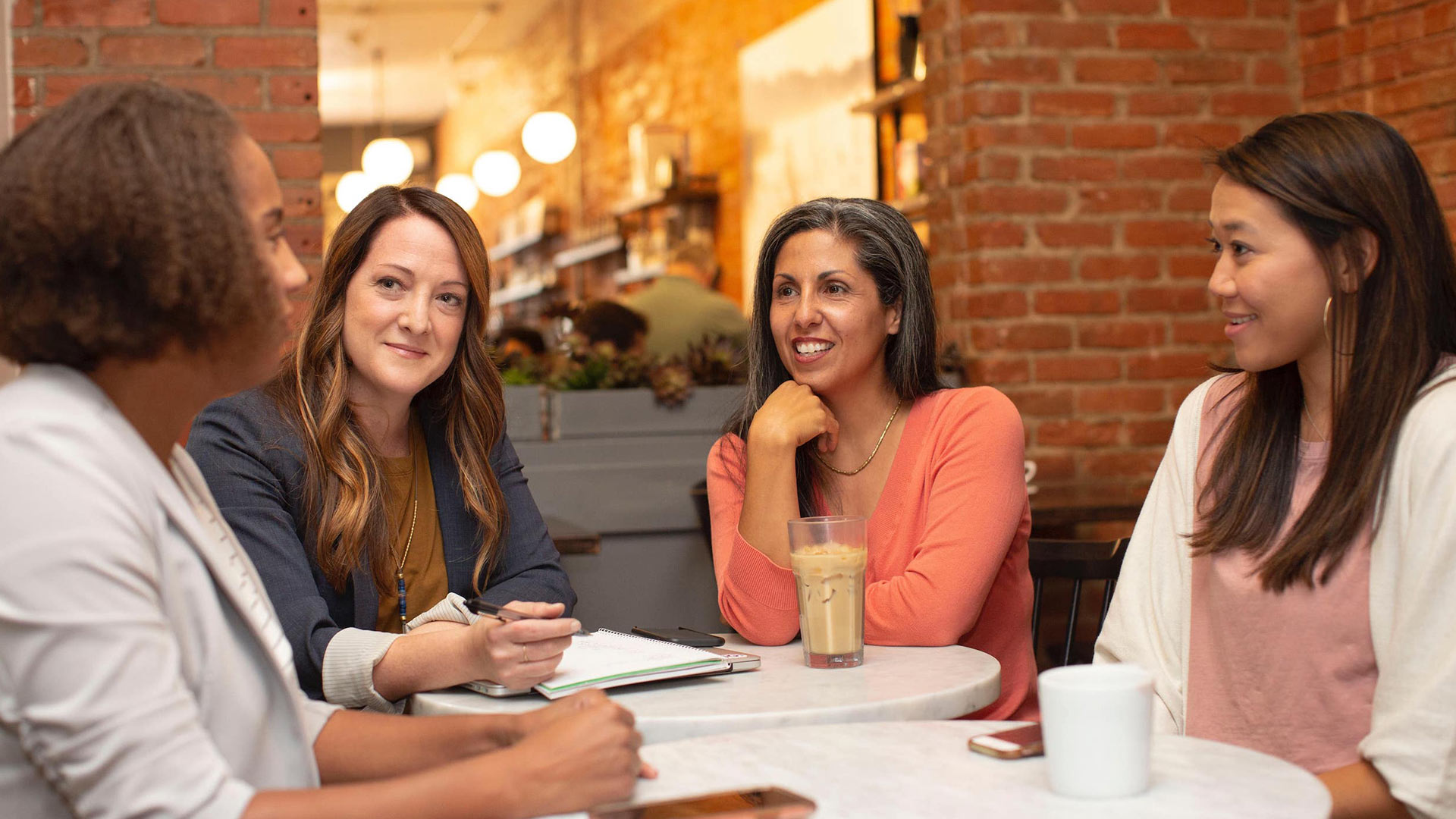 women having a business meeting a cafe
