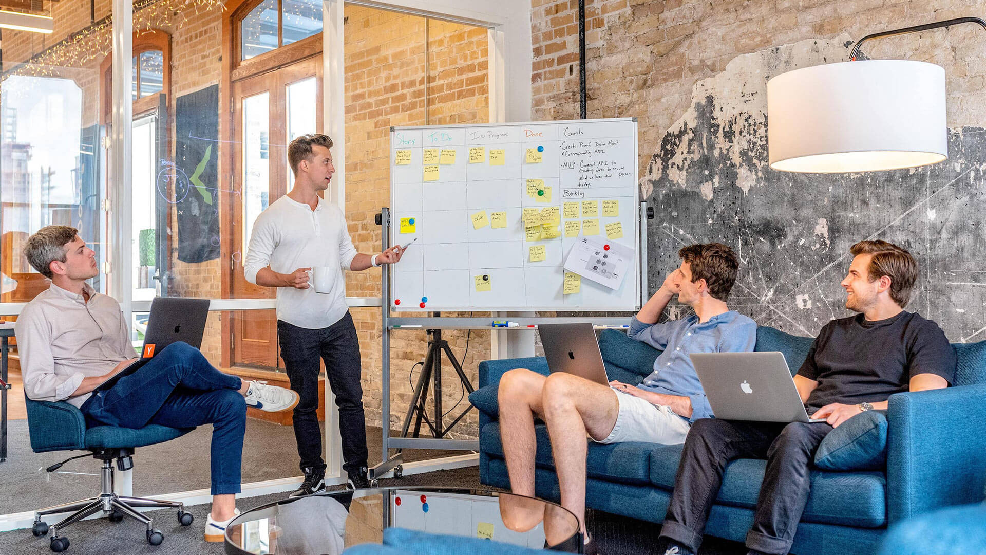 person giving whiteboard presentation to work team