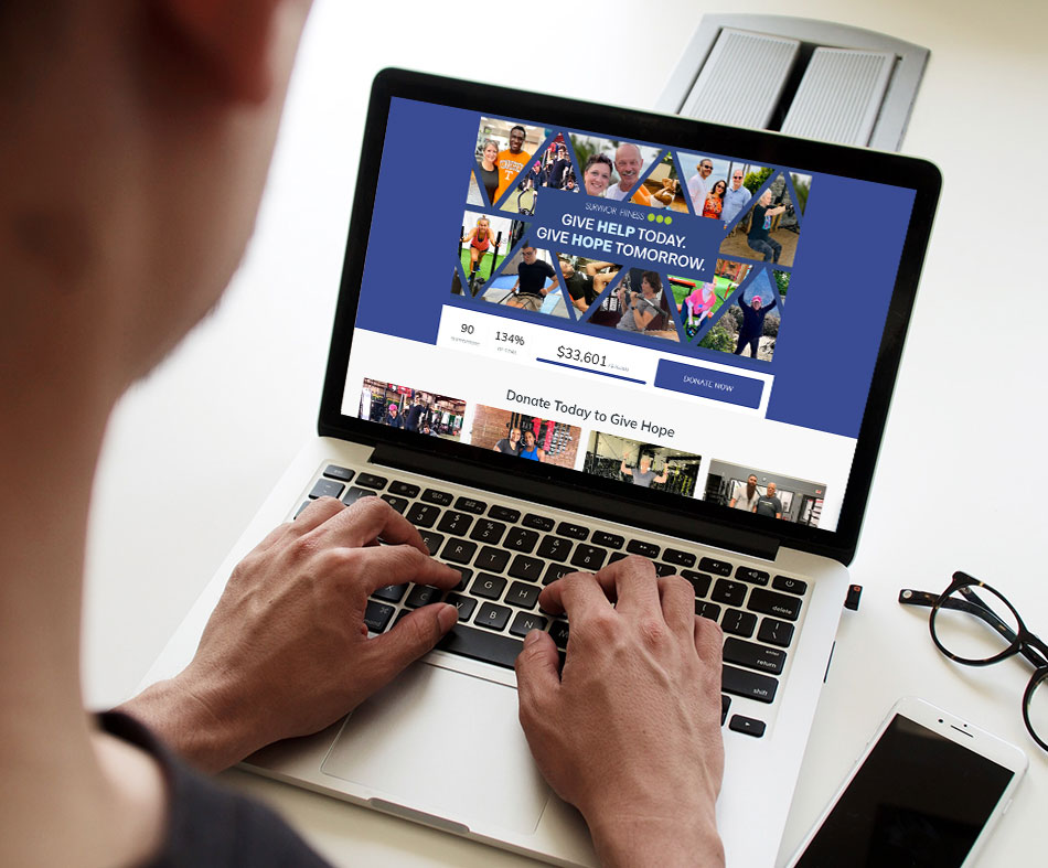 man looking at a computer that shows the success of a Green Apple Strategy fundraising effort