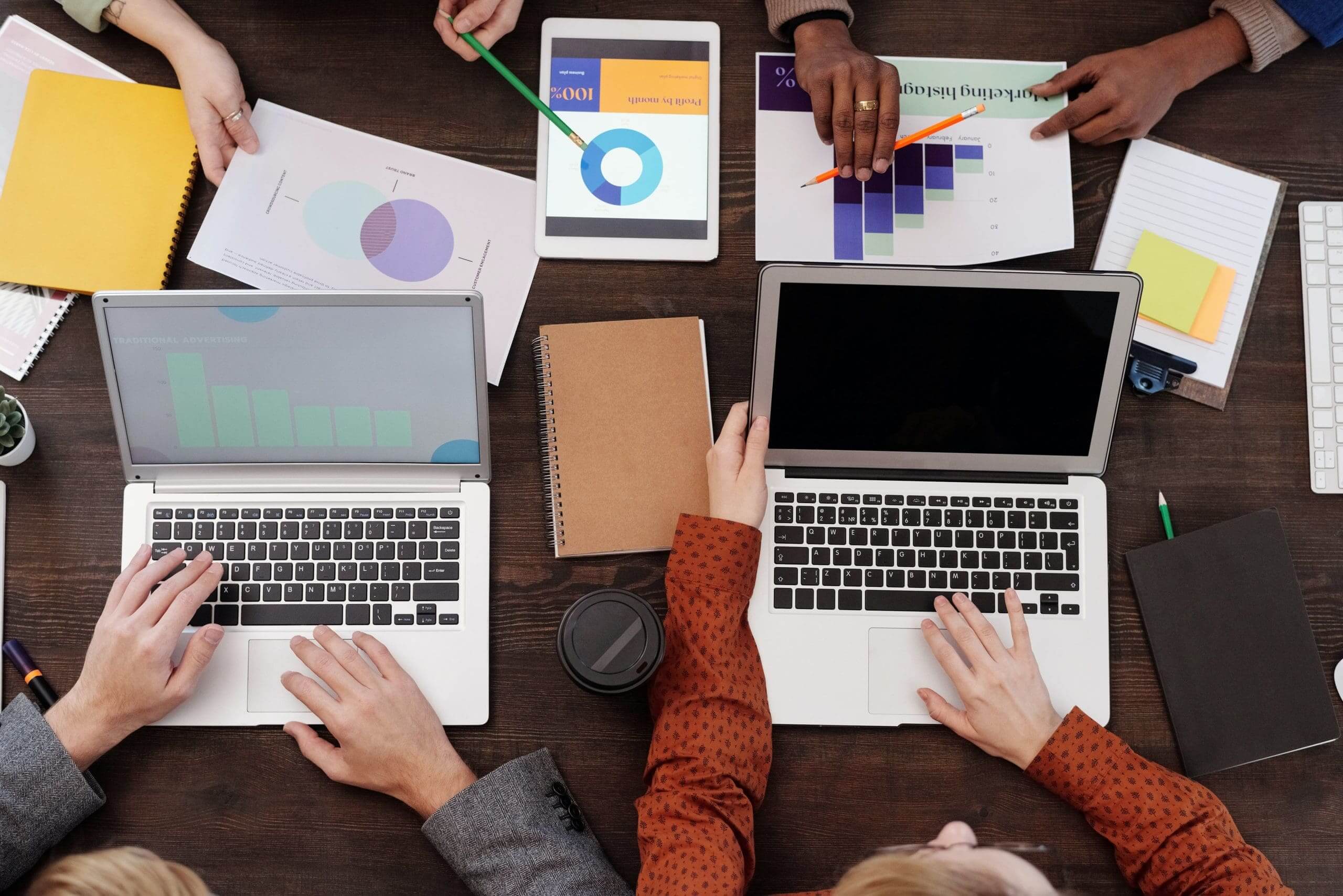 marketers working together over laptops