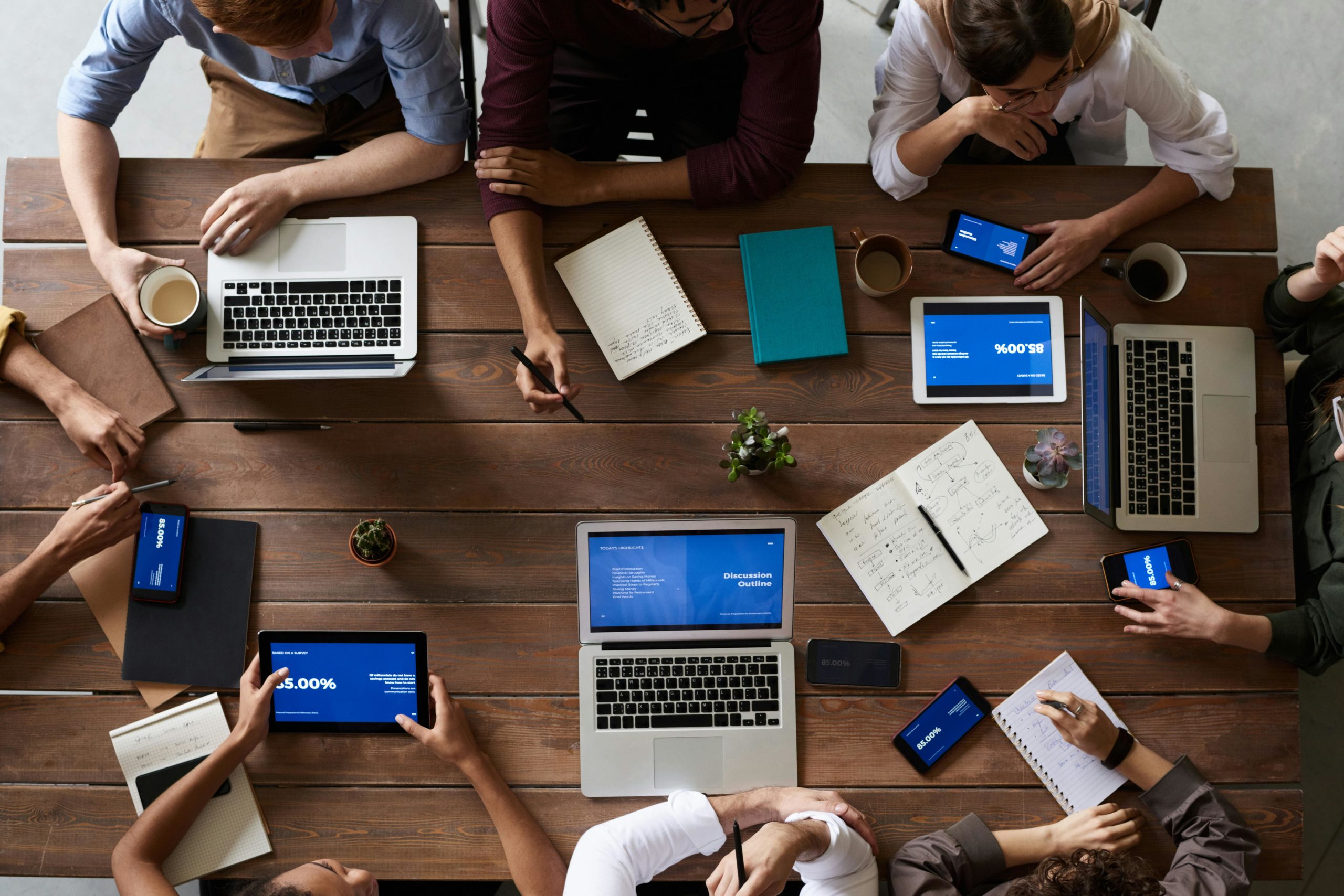 employee team working together at a table over computers