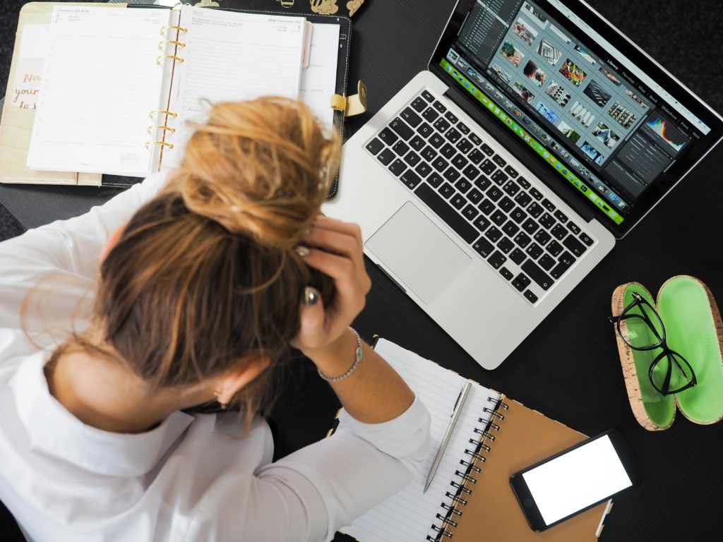 busy woman over laptop and notebooks