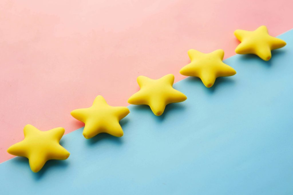 5 yellow stars in a row on pink and blue background