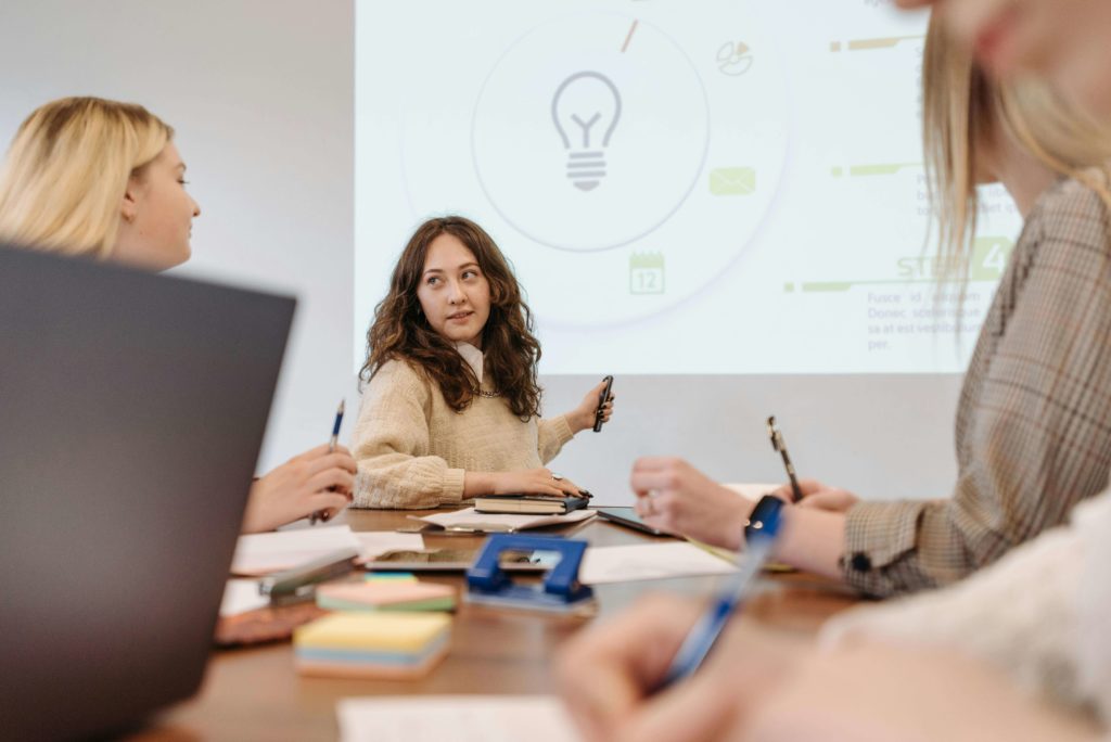 woman presenting marketing wins to team