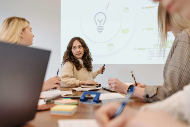woman presenting marketing wins to team